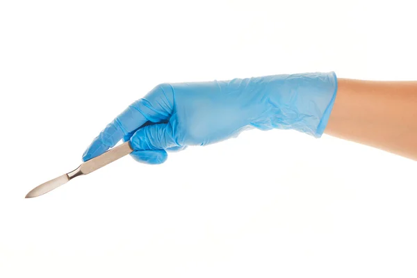 Close up of female doctor's hand in blue sterilized surgical glove with scalpel against white — Stock Photo, Image