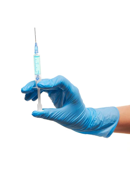 Primer plano de la mano de la doctora en guante quirúrgico azul con jeringa médica plástica llena de medicamento azul —  Fotos de Stock