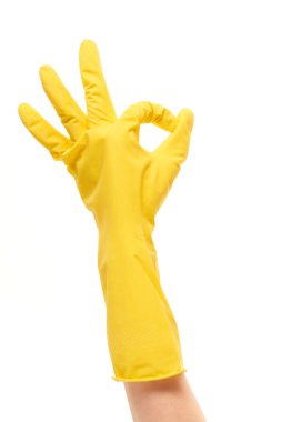 Female hand in yellow protective glove showing OK sign