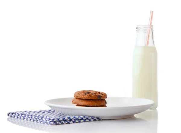 Homemade chocolate chip cookies on white ceramic plate on blue napkin and bottle of milk with straw — Stock Photo, Image