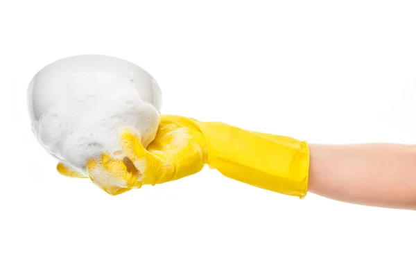 Hand in yellow protective rubber glove holding clean white bowl in foam — Stock Photo, Image