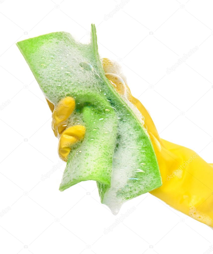 Hand in yellow protective rubber glove holding green rag in foam