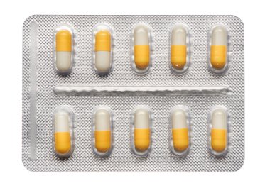 Blister pack of yellow and white capsules clipart
