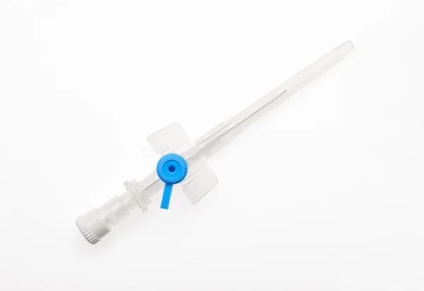 Blue plastic catheter with needle closed by protective cap — Stock Photo, Image