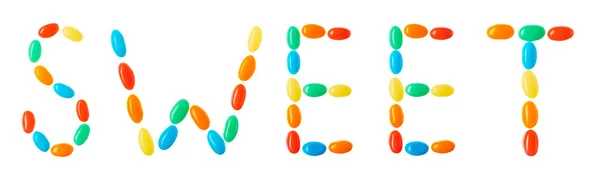 Sweet lettering made of multicolored candies isolated on white — Stock Photo, Image