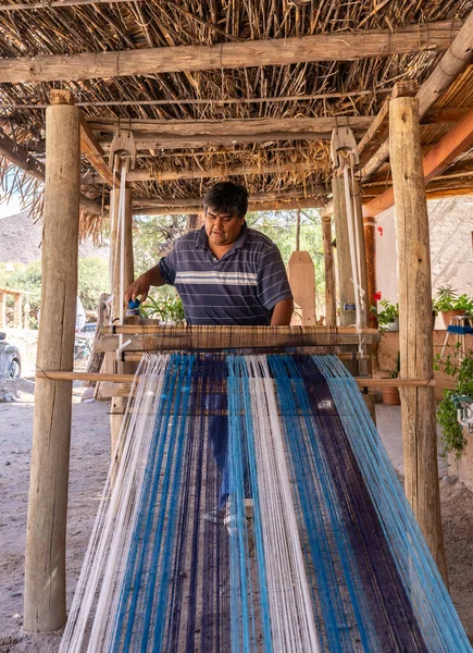 textile weaver craftsman making products on a wooden handicraft loom