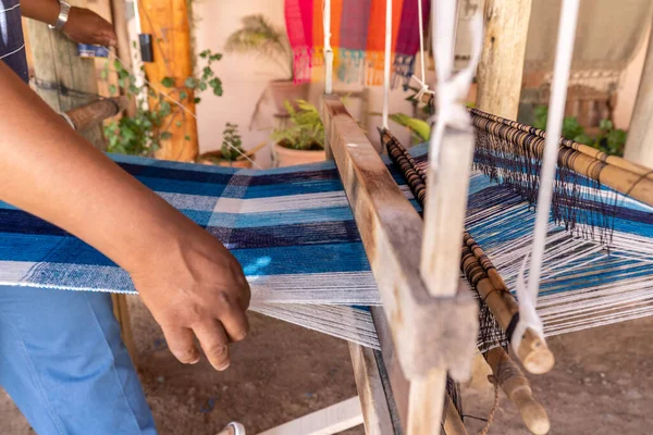 textile weaver craftsman making products on a wooden handicraft loom