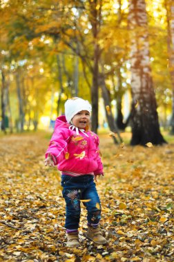 gülüyor ve sonbaharda oynayan bebek kız