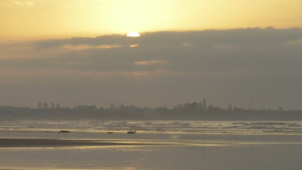 Belo pôr do sol na praia, feixe de luz brilhando através da paisagem nublada — Vídeo de Stock