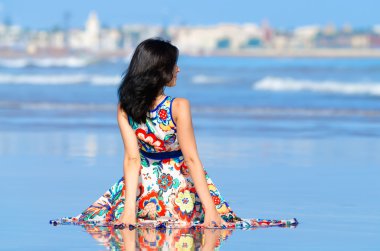 Genç kız okyanus ve şehir bakarak