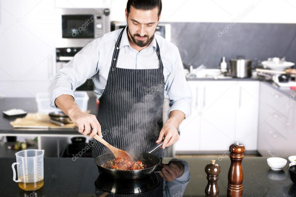 Chef preparing dishes in a frying pan