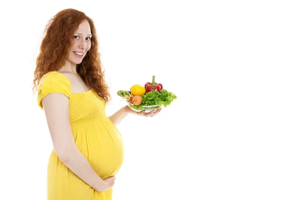 Pregnant woman holding vegetables and smiling — Stock Photo, Image