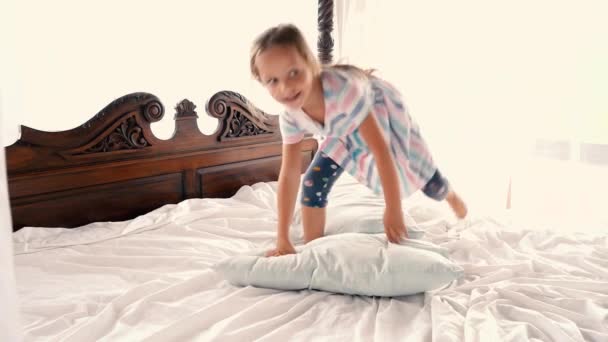 Little girl jumping on the bed at home — Stock Video