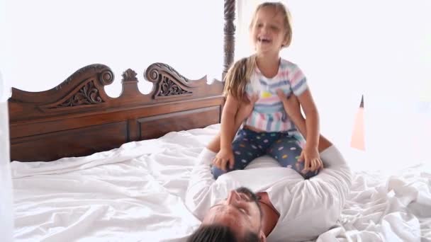 Happy Family Idyll Little Child Daughter Jump On Father Arms And They Fall On A Bed — Stock Video