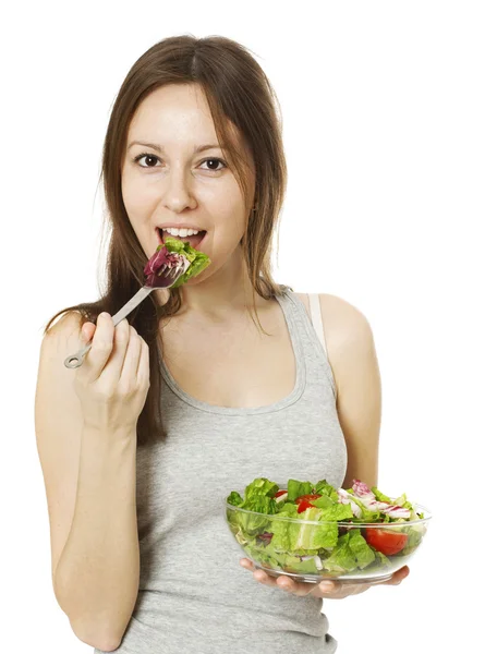 Glad ung kvinna äter sallad. — Stockfoto