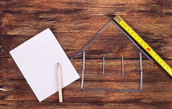 Shape of a home building and paper - Stock Image — Stock Photo, Image