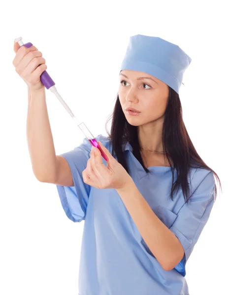 Female doctor holding a doser and tube in her hand. — Stock Photo, Image