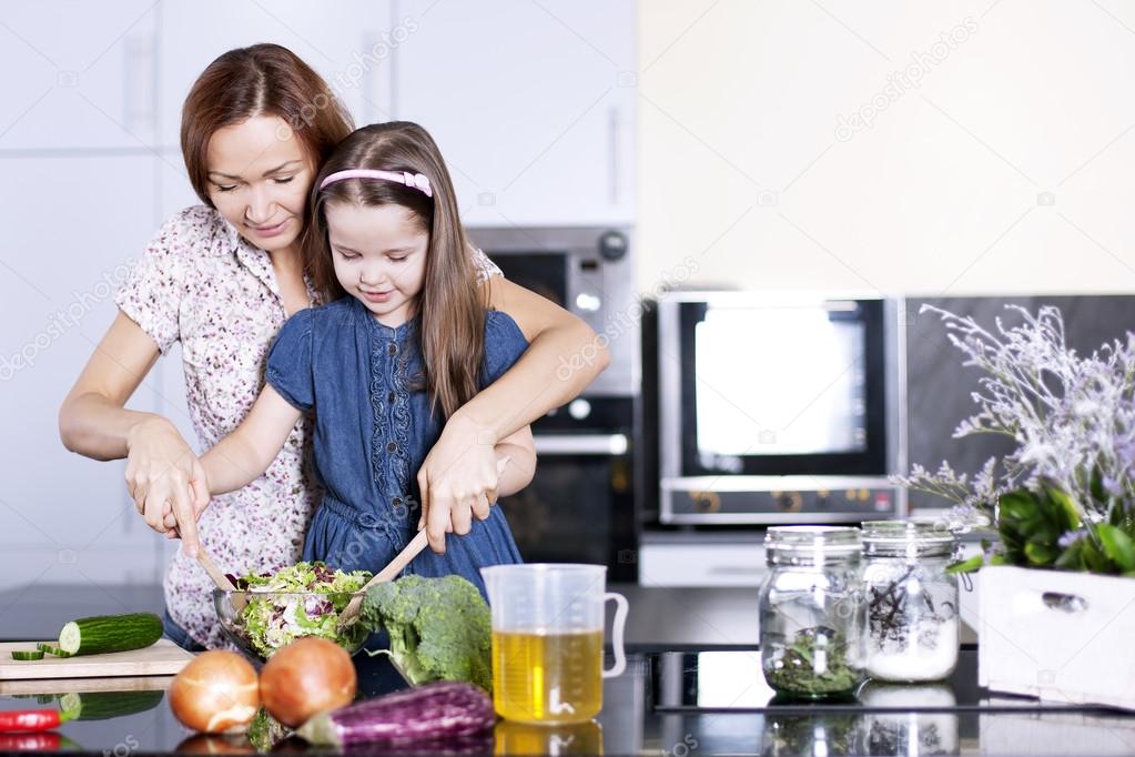 Family Cooking. Mother with little daughter