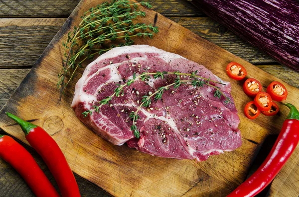 Cooking steak with thyme and chilli. — Stock Photo, Image