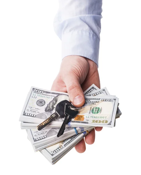 The isolated hundred dollar and keys in a hand - Stock Image — Stock Photo, Image