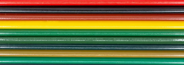 Colored pencils in different colors lined up in rows for banner background, school, art and webdesign. Horizontal panorama