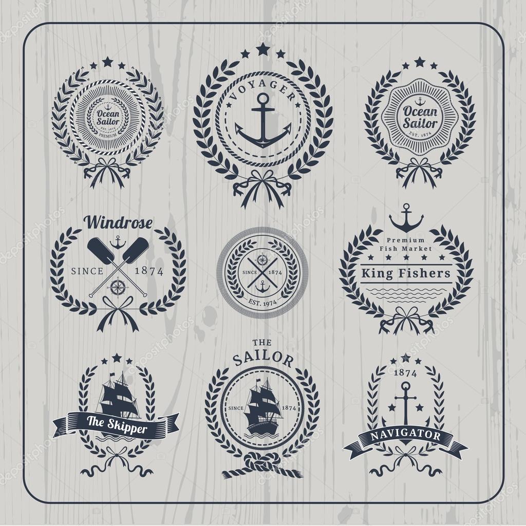 Vintage nautical wreath labels logo set and design element on light wood background.