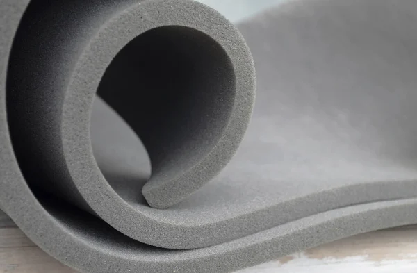 gray sponge foam roll in a spiral style. foam sponge rubber texture sheet