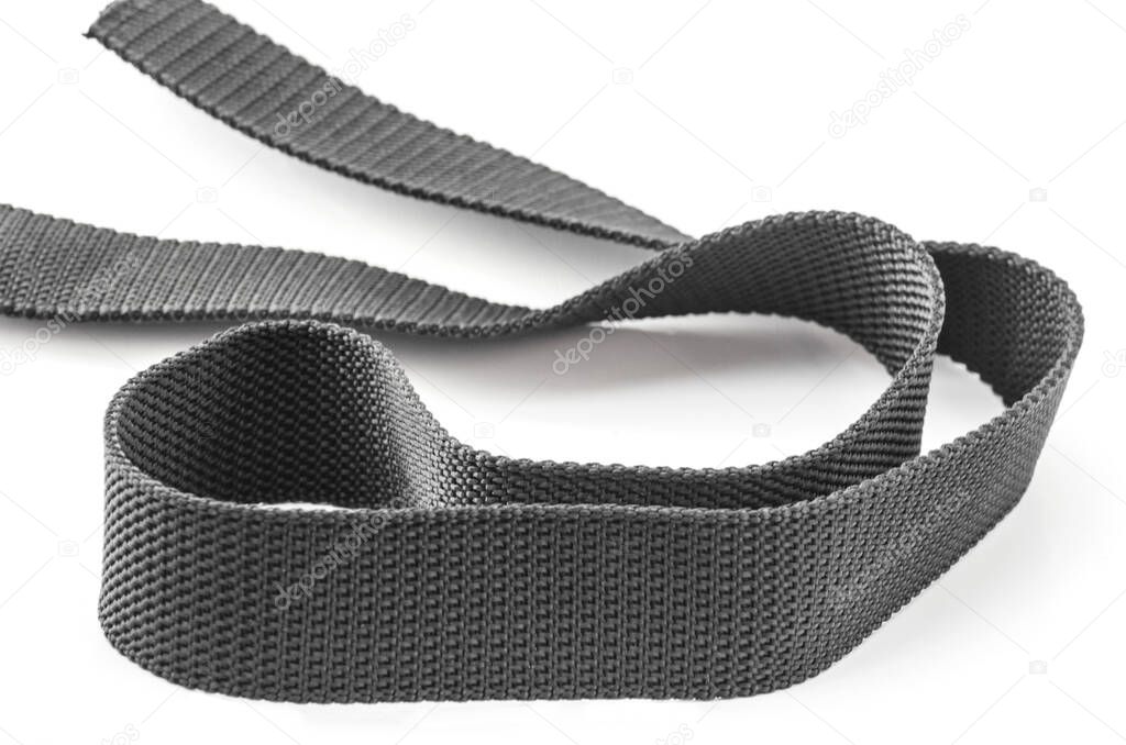 a piece of gray rough textured nylon cloth belt isolated on a white background