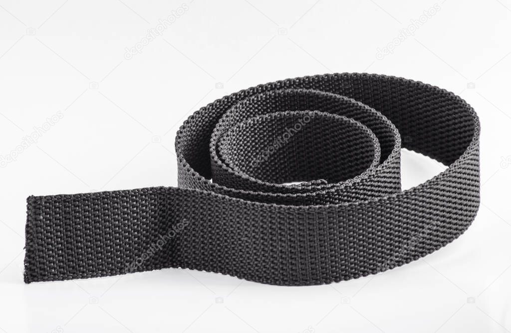 a black or coarse textured nylon cloth belt isolated on a white background