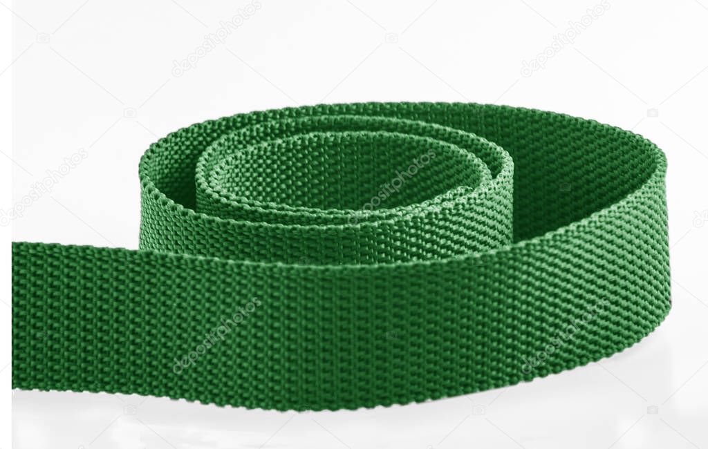 a green rough textured nylon cloth belt isolated on a white background