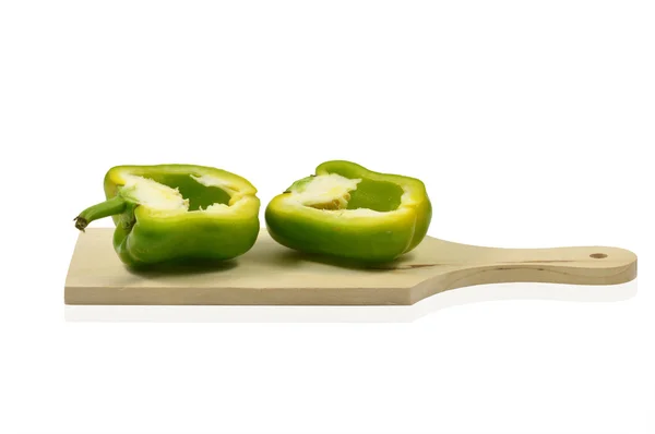 Two halves of green pepper on wooden cutting board — Stock Photo, Image