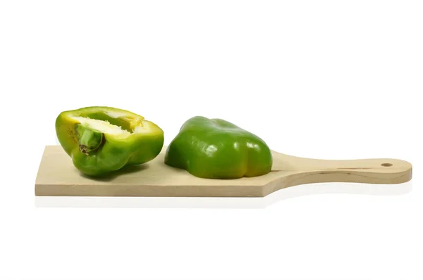 Two halves of green pepper on wooden cutting board — Stock Photo, Image