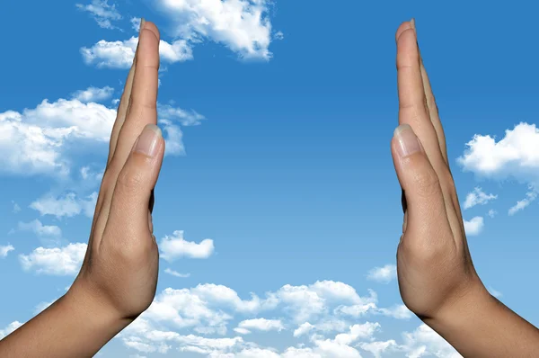Hands over blue sky — Stock Photo, Image