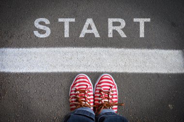 person with sneakers standing in front of the start message clipart