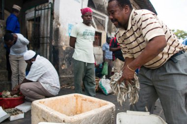 Stone Town, ZANZIBAR - 31 Aralık 2017: İnsanlar Zanzibar 'daki Darajani Market' te satılık karides ve deniz ürünleri hazırlıyorlar.