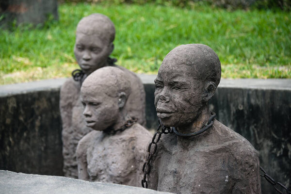 STONE TOWN, ZANZIBAR - JAN 3, 2018: Slavery monument with sculptures and chains near the former slave trade place in Stone town, UNESCO World Heritage Site, Zanzibar.