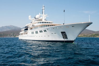 Large luxury motor yacht in the blue sea near coast