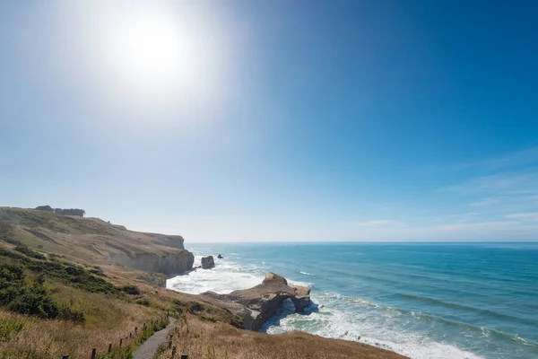 Coastal landscape with Natural arch at Tunnel beach near Dunedin, New Zealand