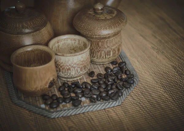 Vintage photo of coffee beans and Coffee cups set on wooden back — Stock Photo, Image