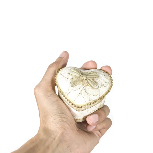 Man holding heart shape gift box and tied with a ribbon in hands — Stock Photo, Image