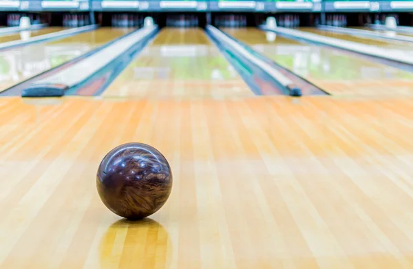 Pallone da bowling marrone con pista da bowling . Fotografia Stock