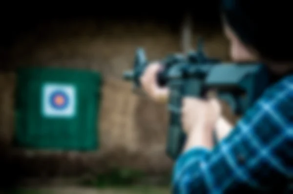 Blurred photo of a woman shooting at a target.