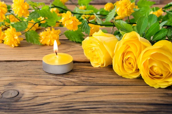 Yellow roses and candle