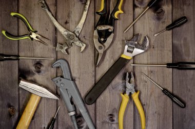 Koyu ahşap arka planda, kopyalama alanı olan çeşitli marangozluk ve çilingir araçları.