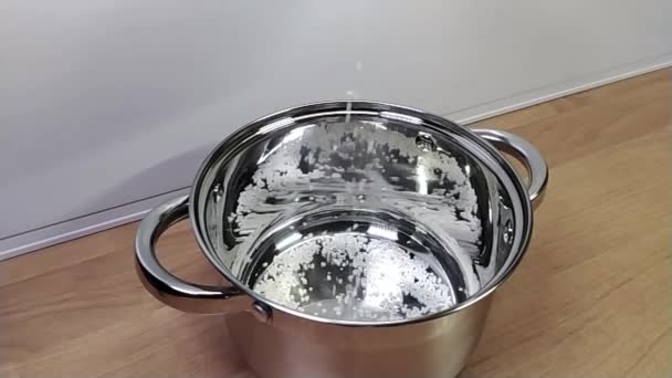 Rice grits falling into a new shiny saucepan for further cooking. Slow motion. — Stock Video