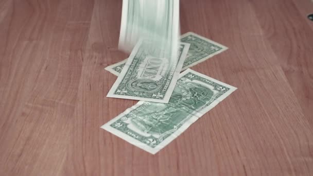 American dollar bills fall on the table, women's hands move the money to themselves. — Stockvideo