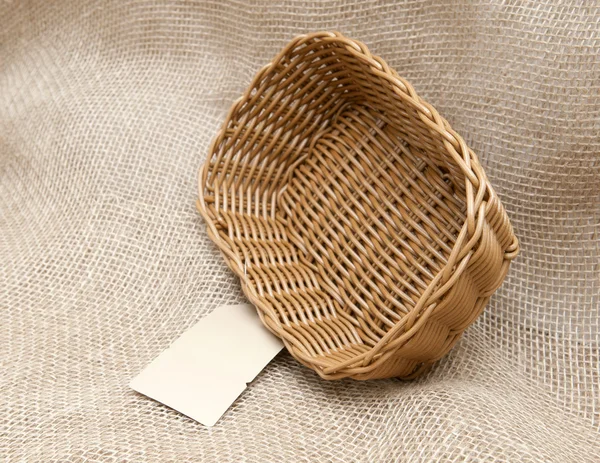 Empty wicker basket on the background fabric — Stock Photo, Image