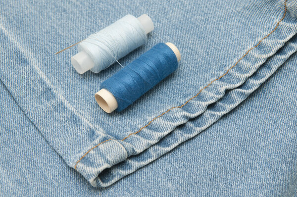 Old torn jeans on a background of burlap. 