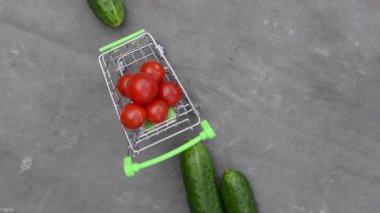 Gri eski kumaşın arka planında sebze rotasyonu olan market sepeti.