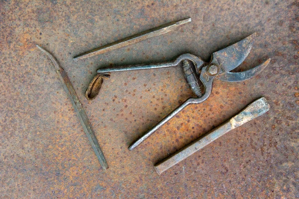 Ancient rusty tools on a metal surface. Steampunk style.